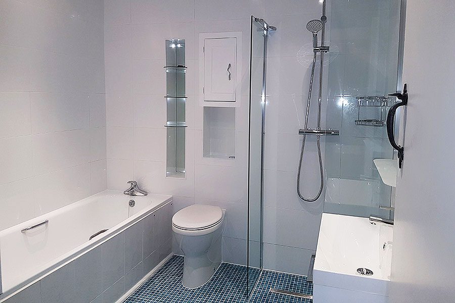 Disability bathroom with raised height toilet and wetroom show by Room H2o