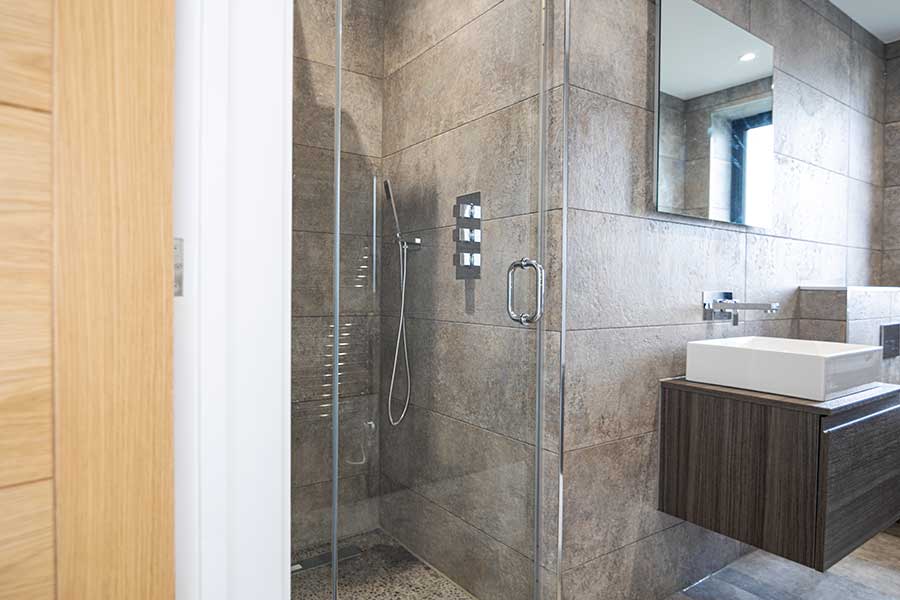 10mm glass bespoke frameless hinged shower door by Room H2o at a new build home in Canford Cliffs Dorset