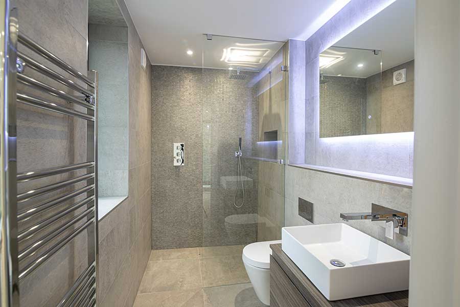 Wetroom featuring a large floor to ceiling bespoke frameless shower screen by Room h2o in Poole Dorset