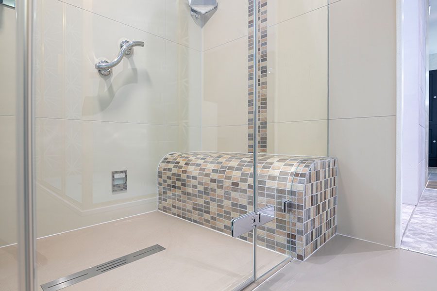 Tiled wetroom at Room H2o featuring large format and mosaic wall and floor tiles