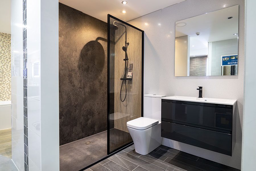 Stone effect floor tiles and shower wall cladding on display at Room H2o