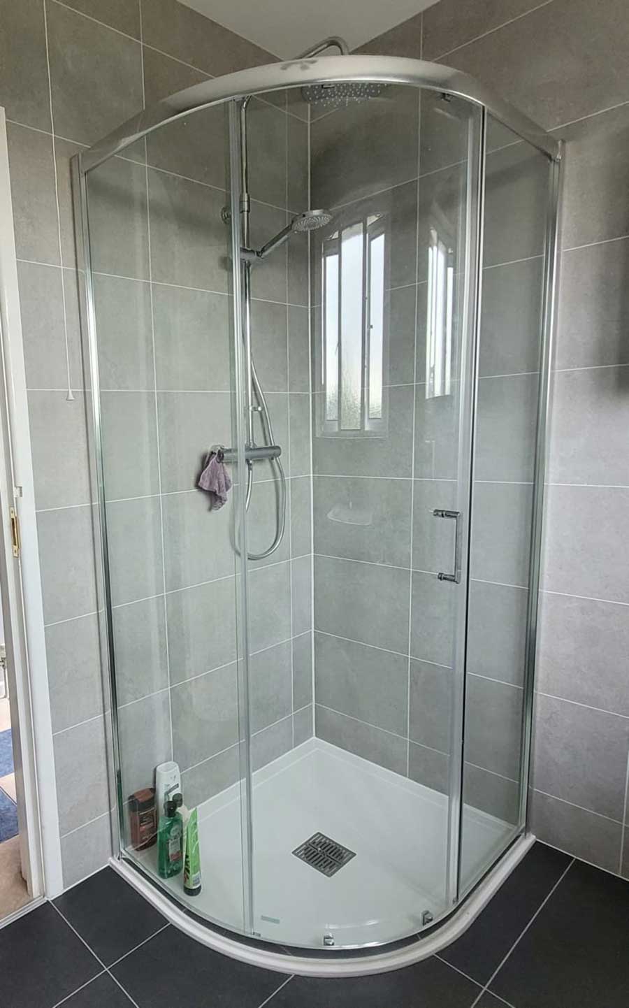 Curved quadrant shower enclosure with R2 Jot thermostatic shower valve and riser kit with hand shower and drench shower head