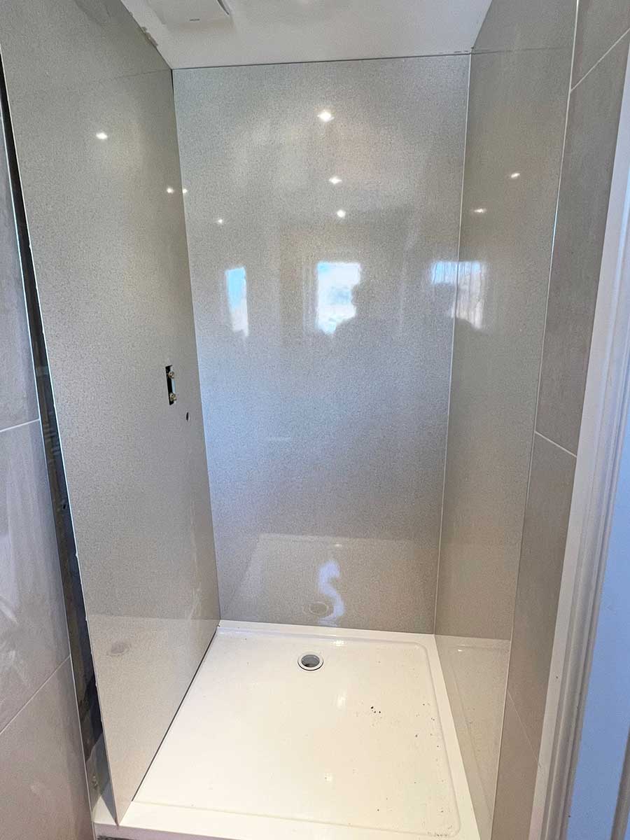 Installing new BB Nuance Vanilla Quartz shower wall panels to correct a leaking shower in Dorset