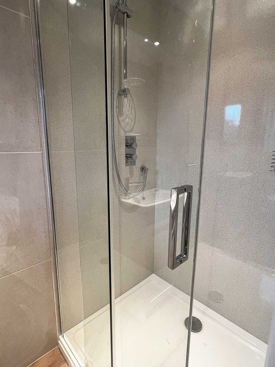 Crosswater Design sliding shower door and BB Nuance shower wall panels installed by Room H2o at a flat in Swanage Dorset